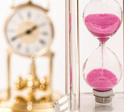 a clock and a vase of flowers