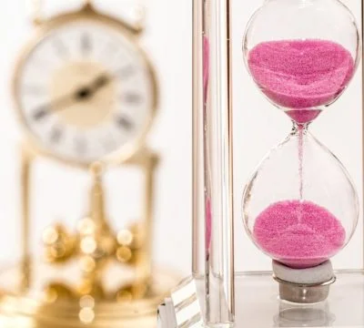 a clock and a vase of flowers