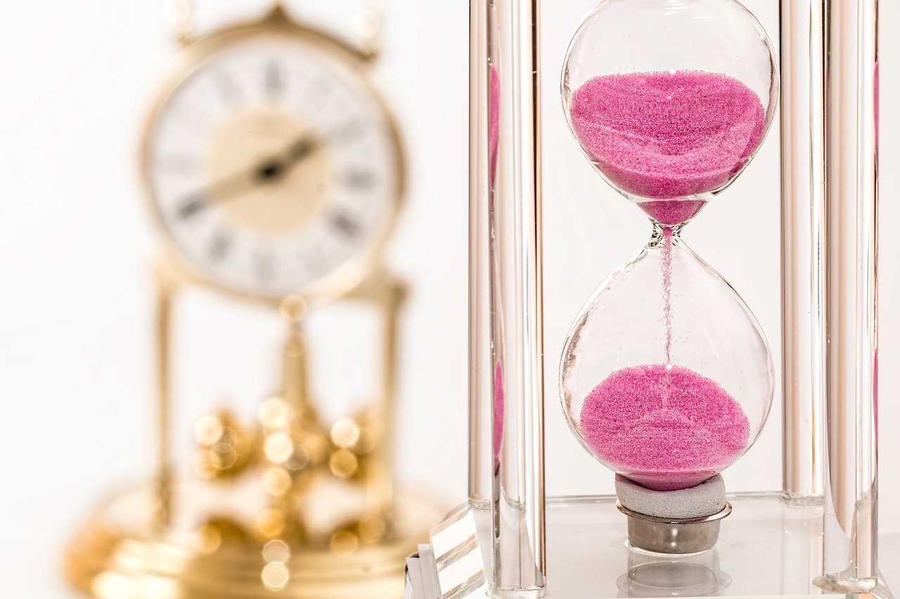 a clock and a vase of flowers