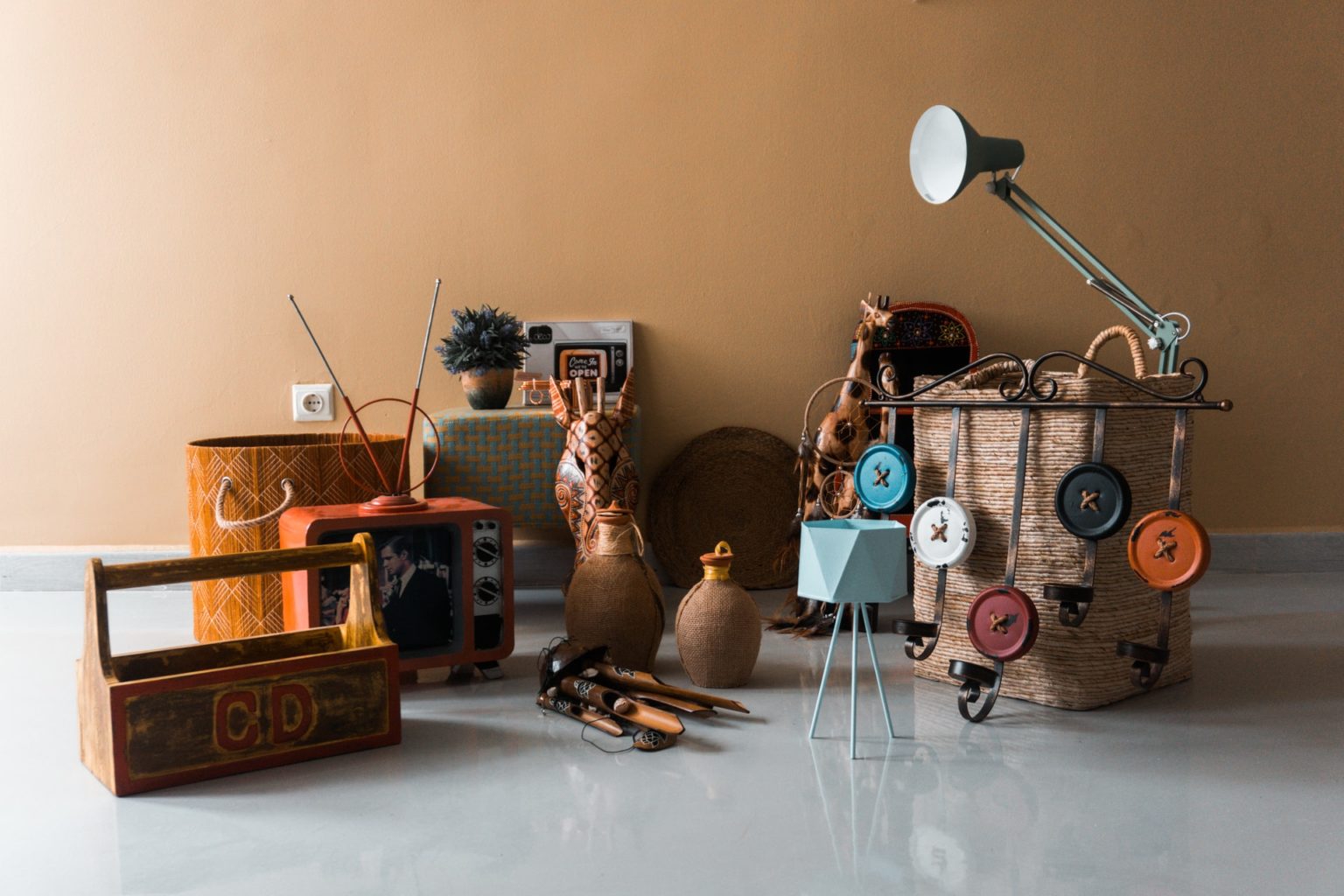 a room with a table lamp and other objects on the floor