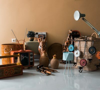 a room with a table lamp and other objects on the floor