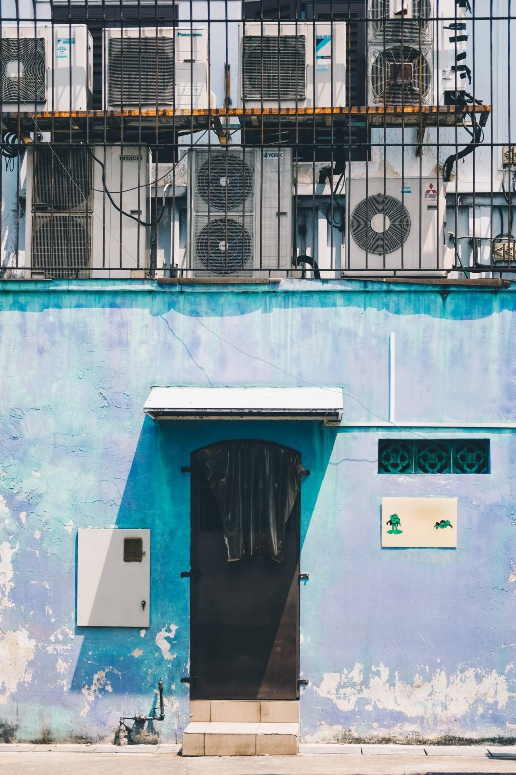 a blue building with a black door