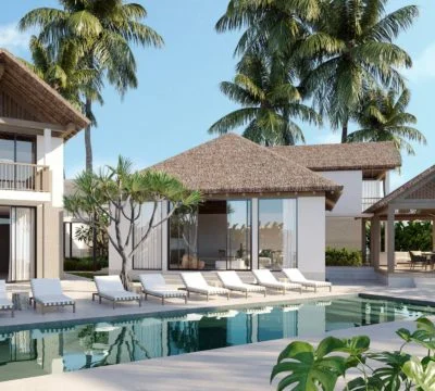 a pool with lounge chairs and a cabana