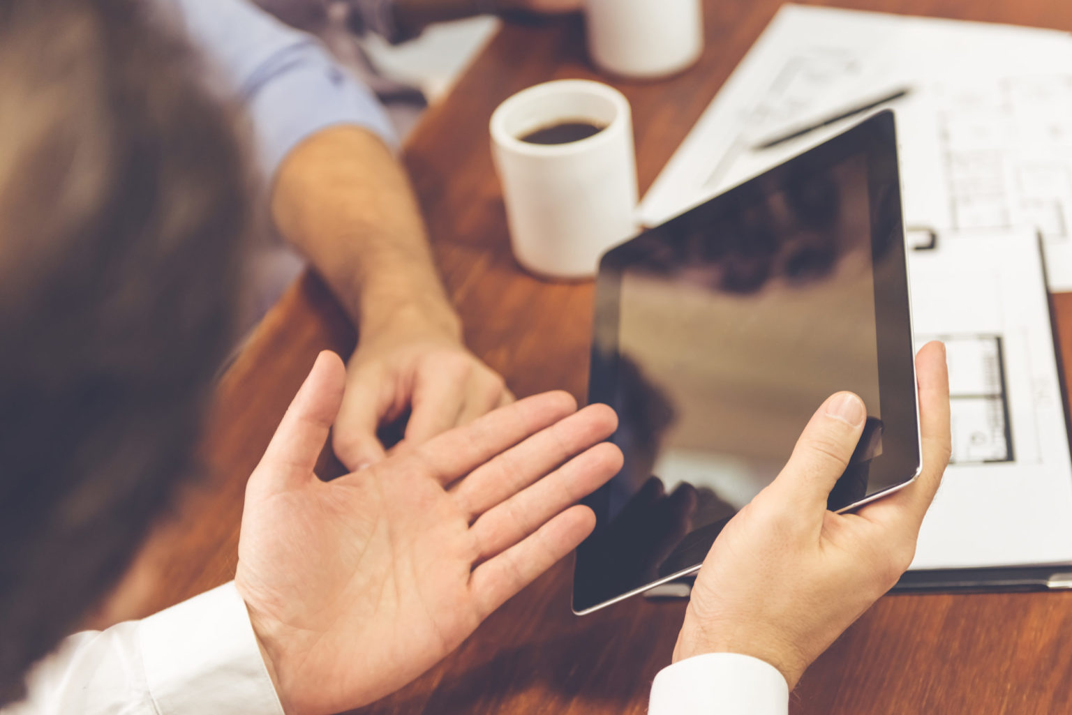 a few hands holding a phone